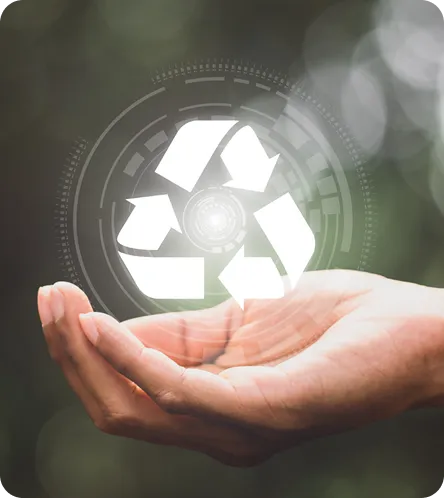 Hands holding a glowing digital recycling symbol against a natural background, symbolizing a commitment to sustainable manufacturing and the circular economy.
